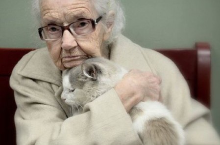 A senior citizen with her cat.